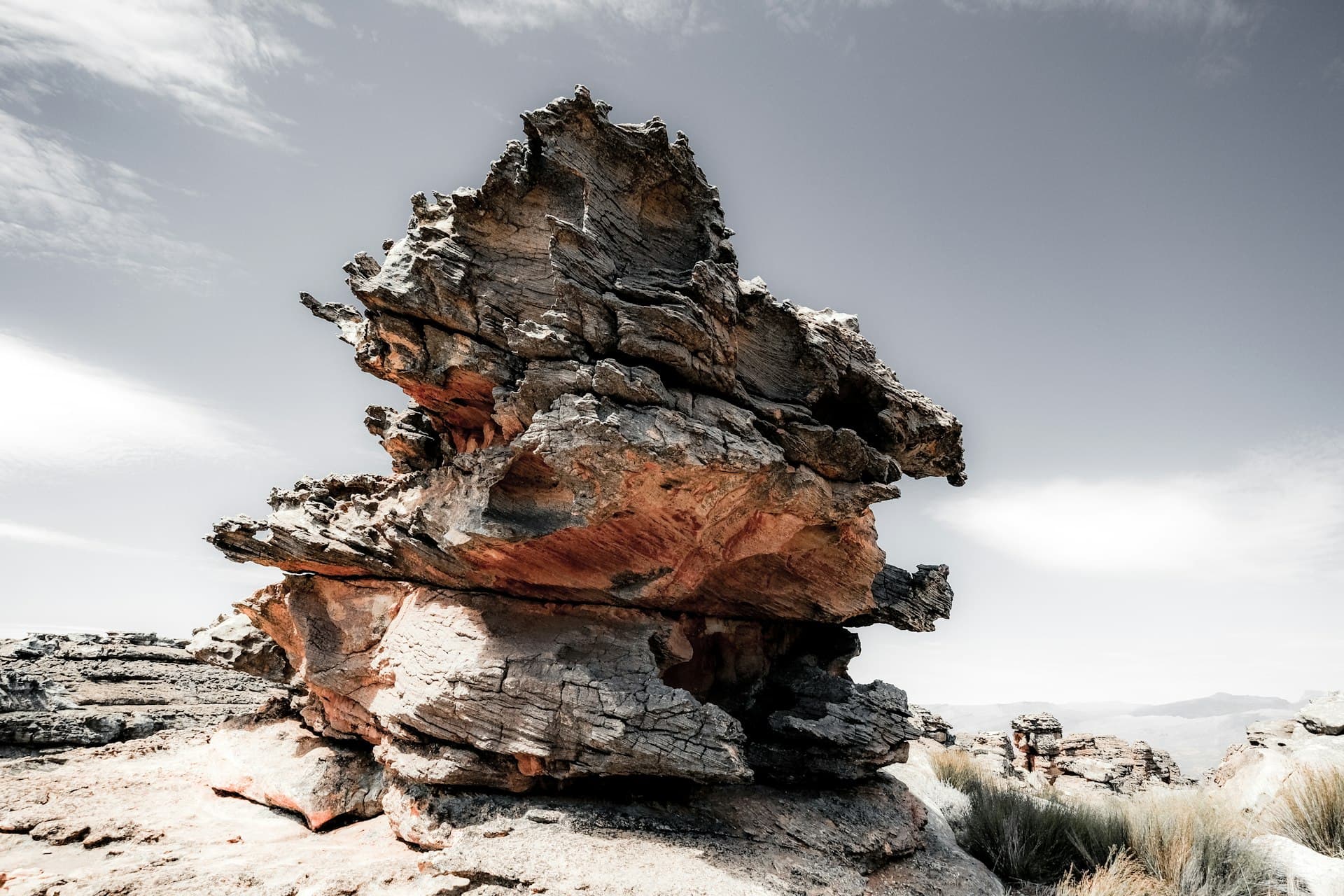 A weathered sandstone rock formation under a pale sky in South Africa